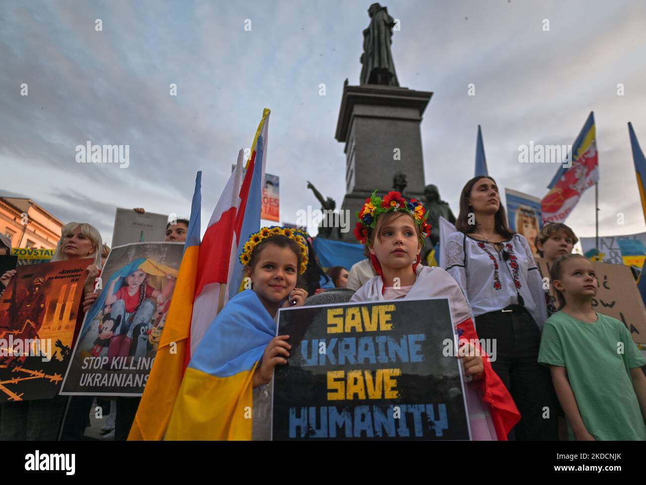 Two young protesters hold a placard with words 'Save Ukraine Save Humanity'. Members of the local Ukrainian diaspora, war refugees, peace activists, volunteers and local supporters during the 'Be Brave Like Azovstal Heroes' demonstration in defense of the heroic soldiers of Azovstal on the 122nd day of the war. On Saturday, June 25, 2022, in Main Market Square, Krakow, Poland. (Photo by Artur Widak/NurPhoto) Stock Photo