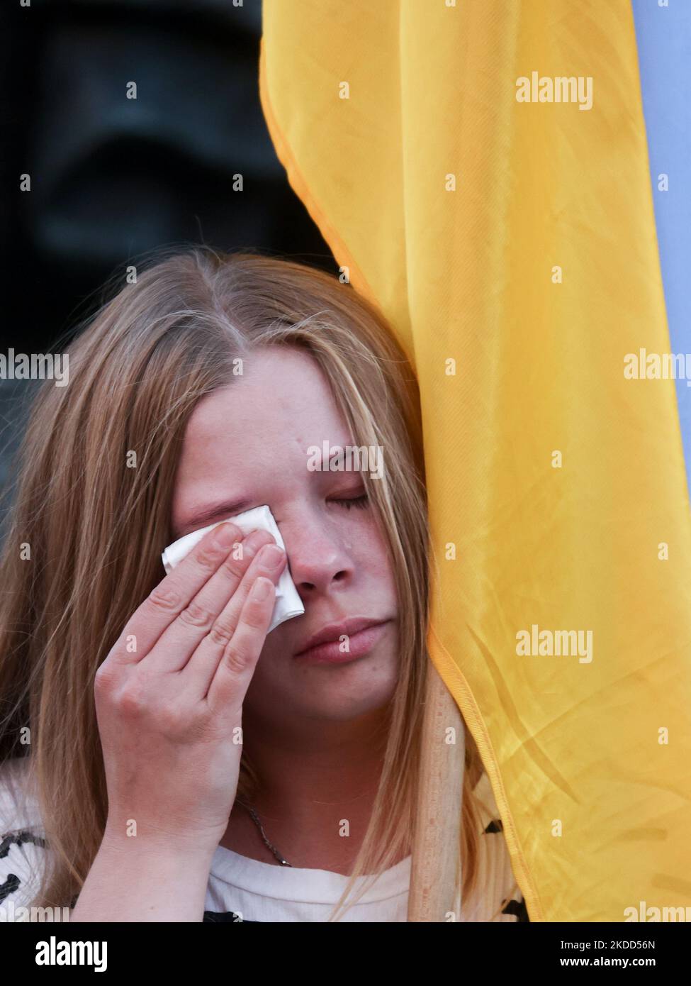 A woman wipes the tears during the demonstration at the Main Square in support of Azovstal 4308 regiment defenders that are currently in Russian captivity. Krakow, Poland on July 3rd, 2022. The Azov Regiment was among the Ukrainian units that defended the steelworks in the city of Mariupol for nearly three months before surrendering in May under relentless Russian attacks from the ground, sea and air. (Photo by Beata Zawrzel/NurPhoto) Stock Photo