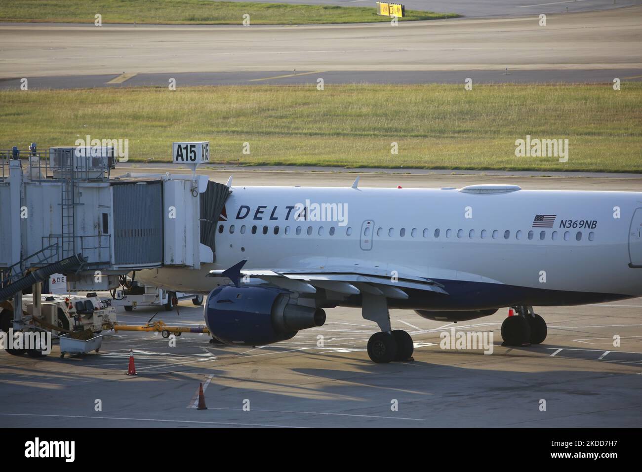 A Delta Air Lines plane can be seen at a terminal in Bush
