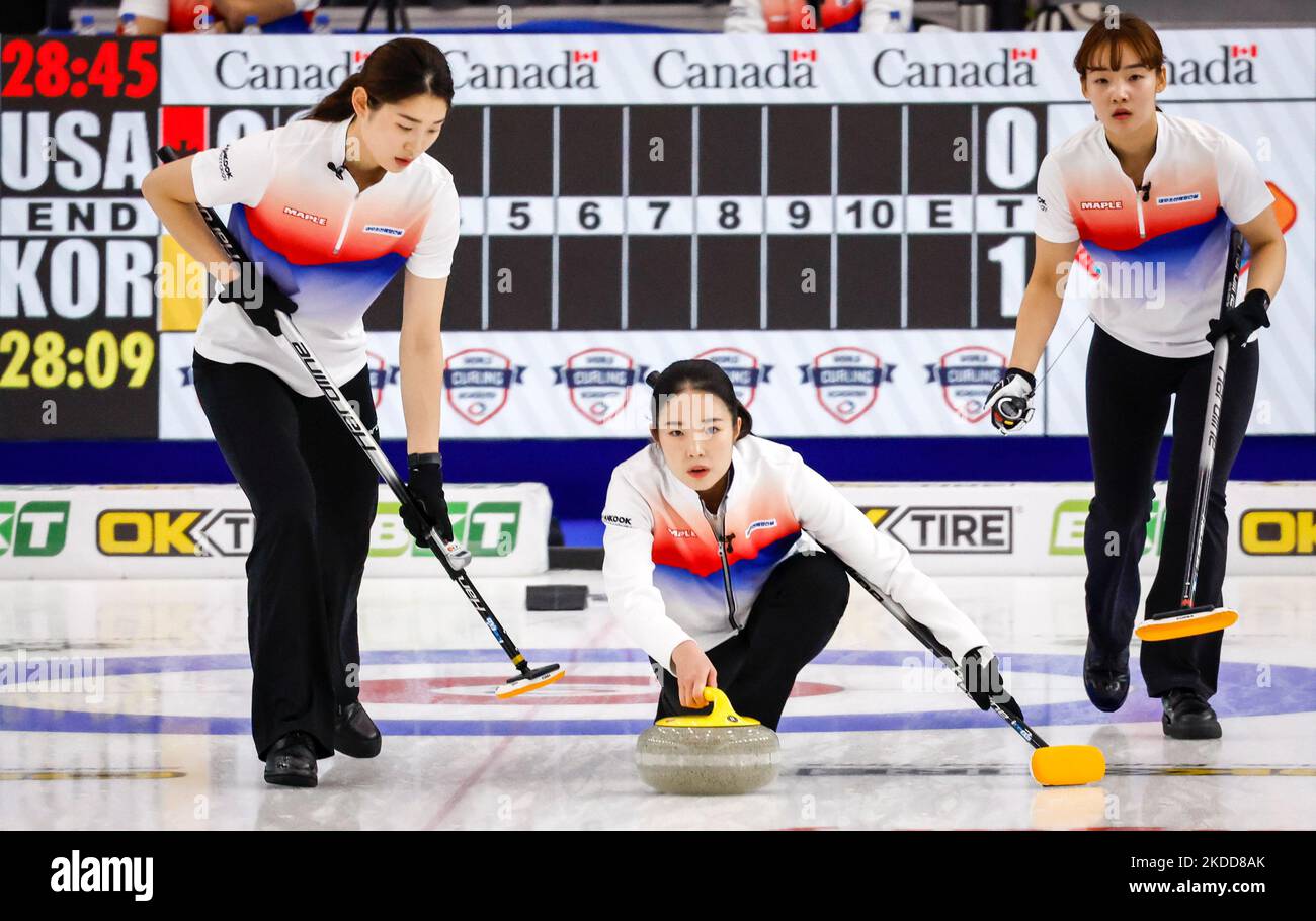 Korea skip Ha Seung-youn, centre, makes a shot as lead Kim Su-jin, right, and second Yang Tae-i look on during womens semi-final playoff action against the United States at the Pan Continental Curling Championships in Calgary, Alberta, Saturday, Nov