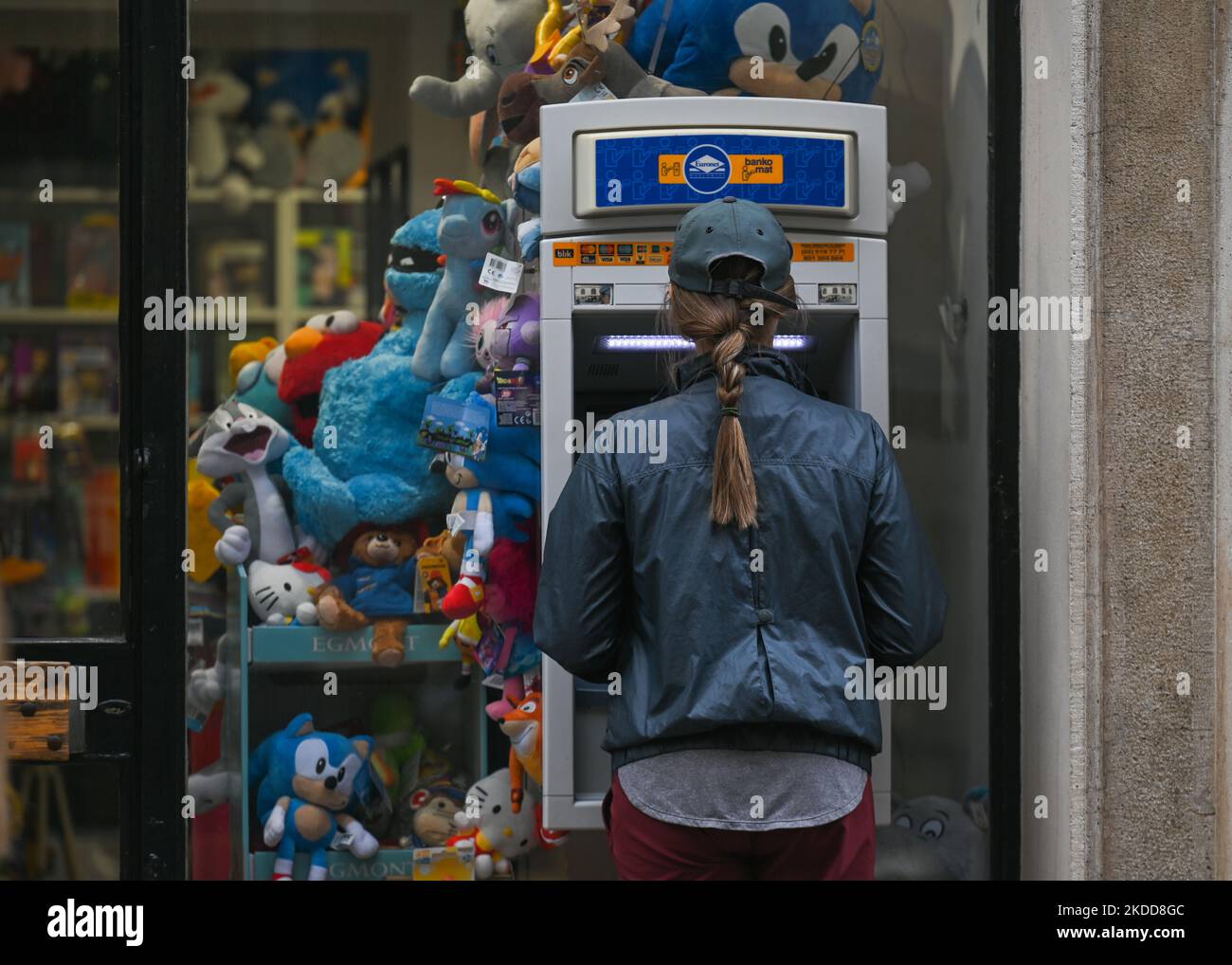 A woman uses an ATM machine in the center of Krakow. On Wednesday, July 06, 2022, in Krakow, Poland. (Photo by Artur Widak/NurPhoto) Stock Photo