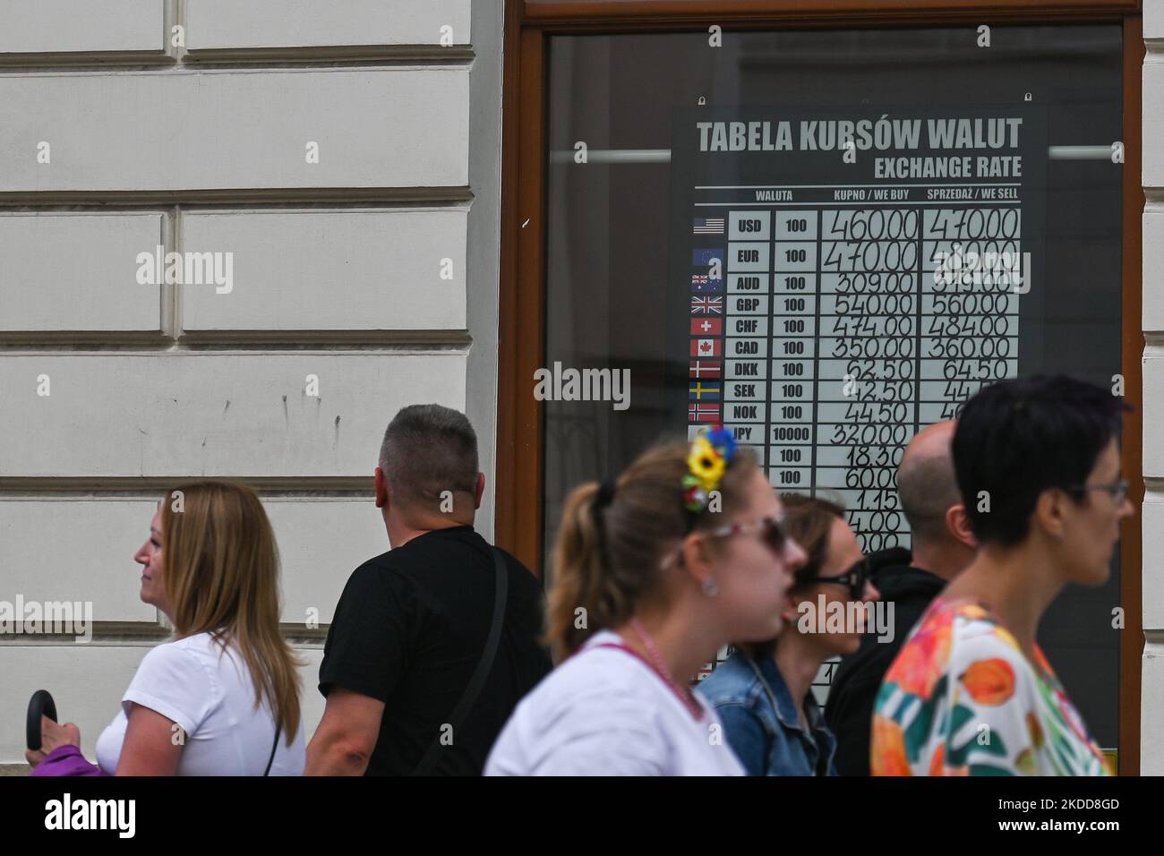 People walk past a sign with different exchange rates seen in the window of an exchange office in Krakow's Old Town. On Wednesday, July 06, 2022, in Krakow, Poland. (Photo by Artur Widak/NurPhoto) Stock Photo