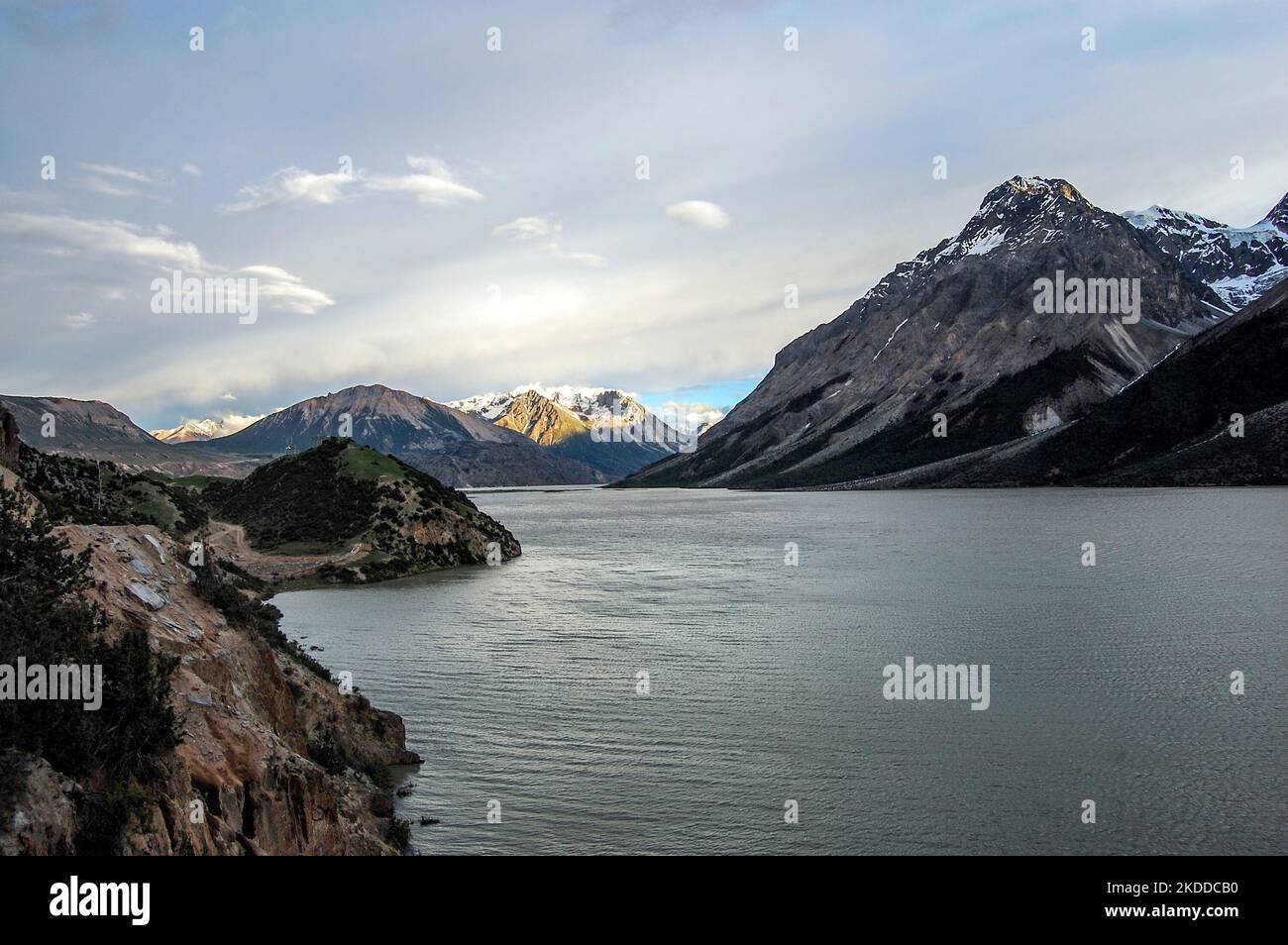 A beautiful view of a lake and the mountains under a cloudy sky Stock ...