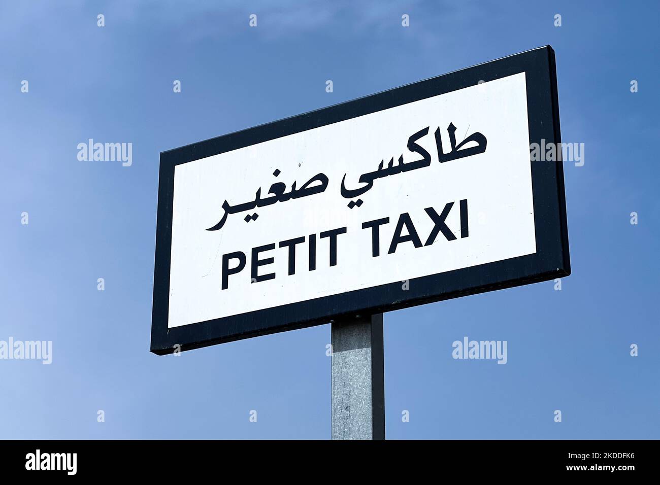 Amall taxi signpost with blue sky in the background Stock Photo