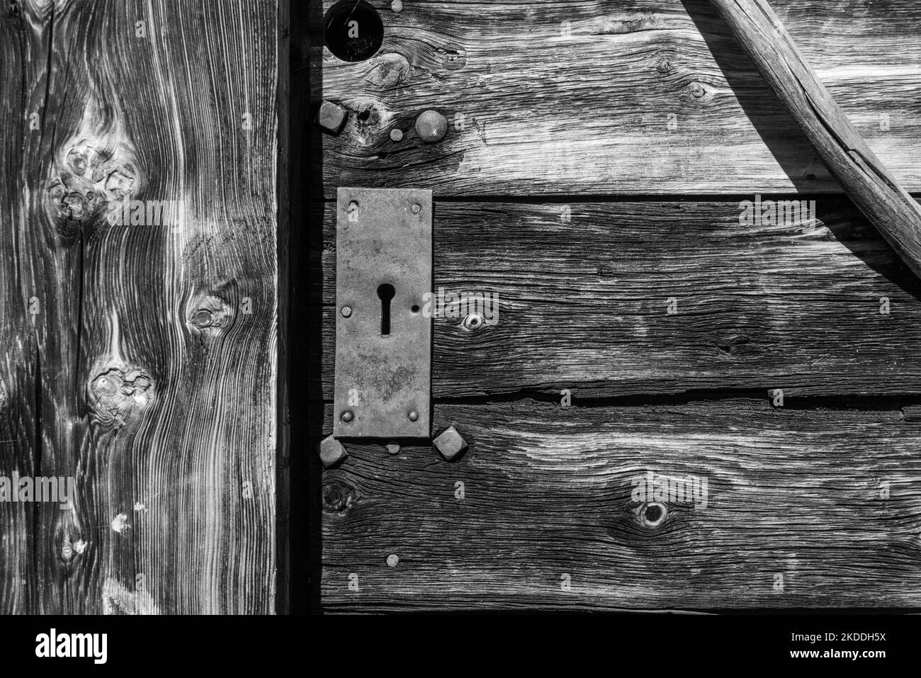 Closeup of a wooden door of a typical Alpine hut, the Dolomite Alps in