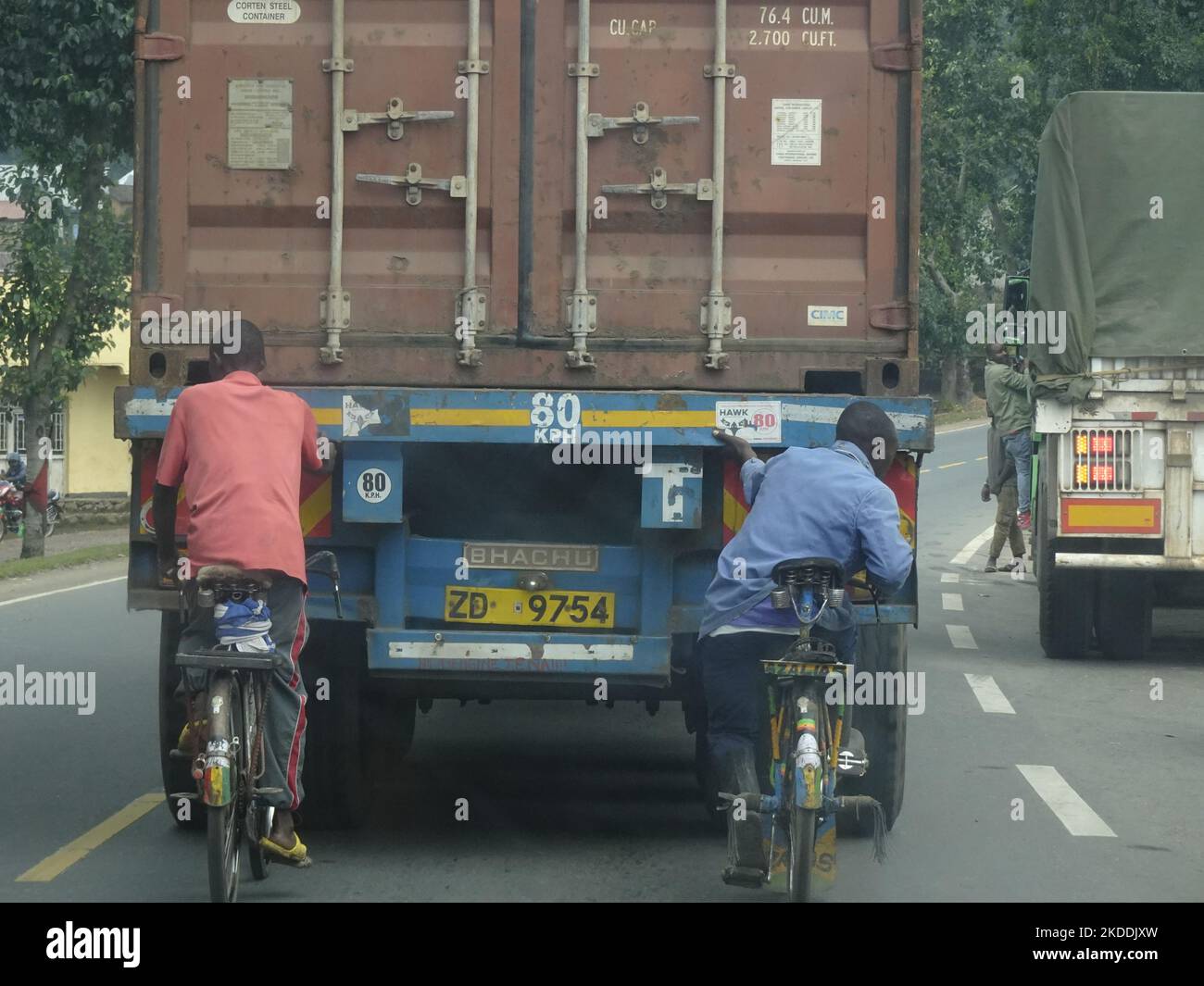 On route to Kigali, Rwanda 31st August 2022 Cyclists hanging on a truck