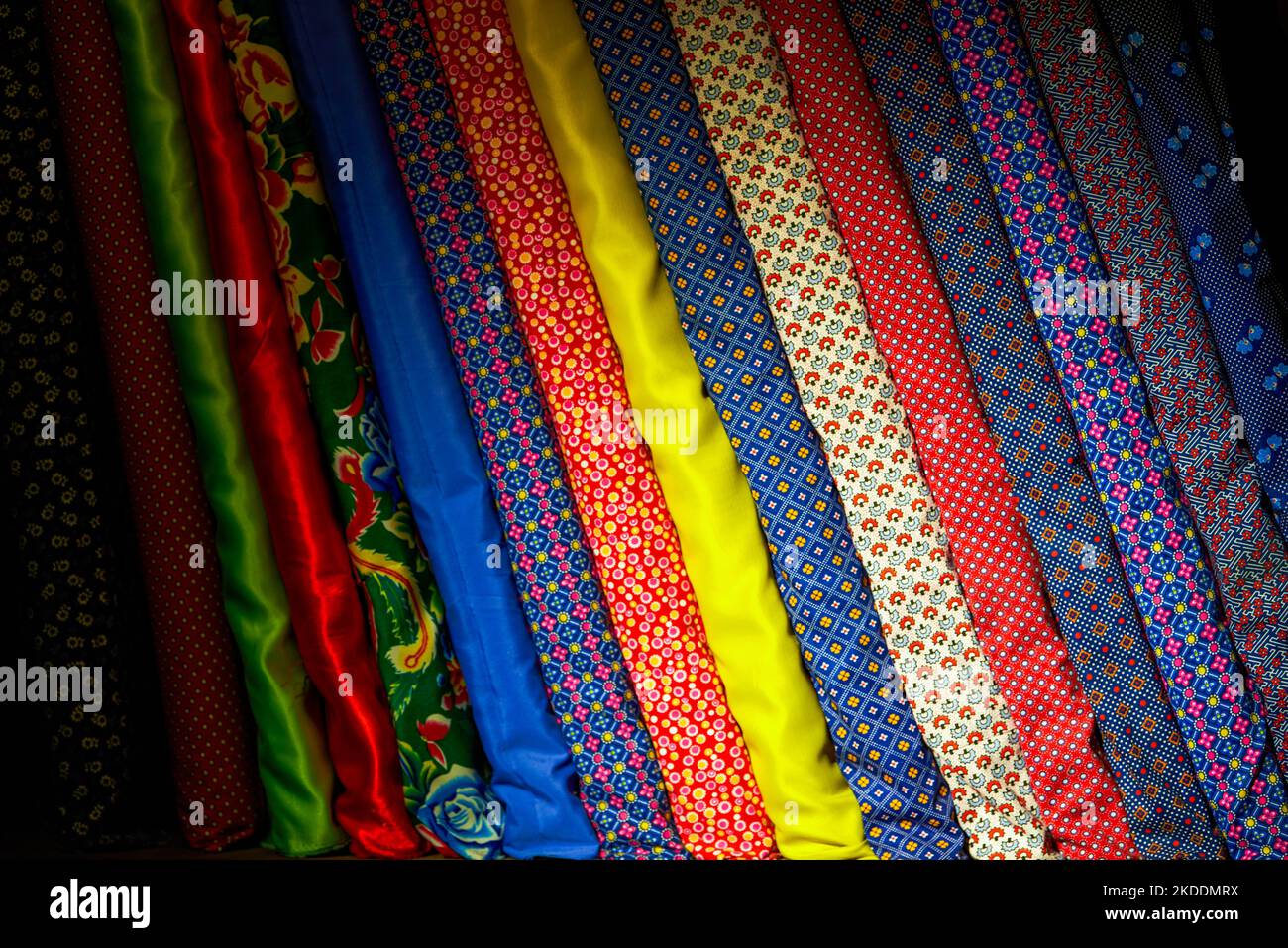 Closeup of pieces of cloth of various colors and styles in a tailor shop Stock Photo