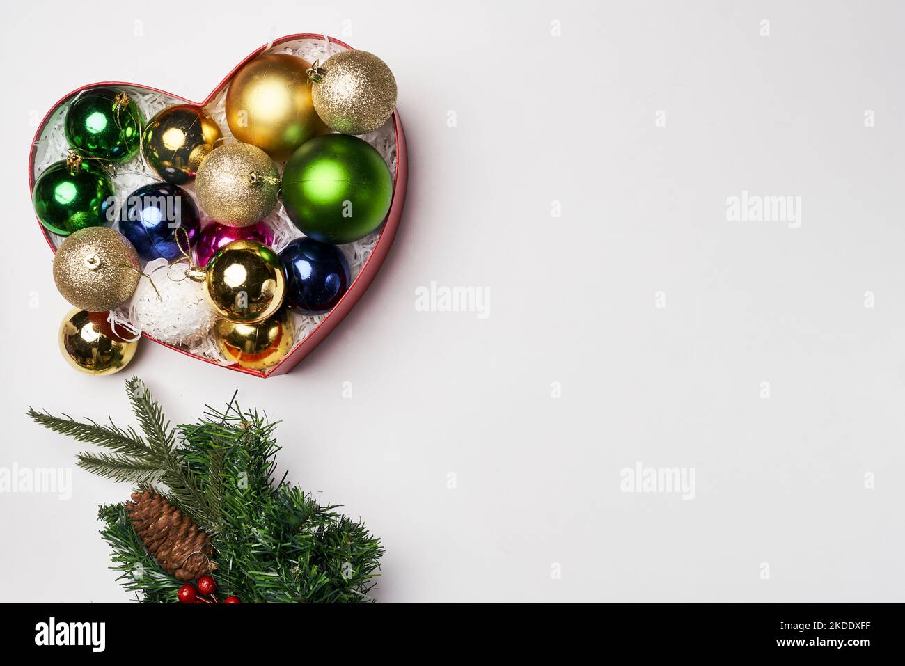 christmas ornaments in a heart shaped box on a white background with copy space for your own text or other contents Stock Photo