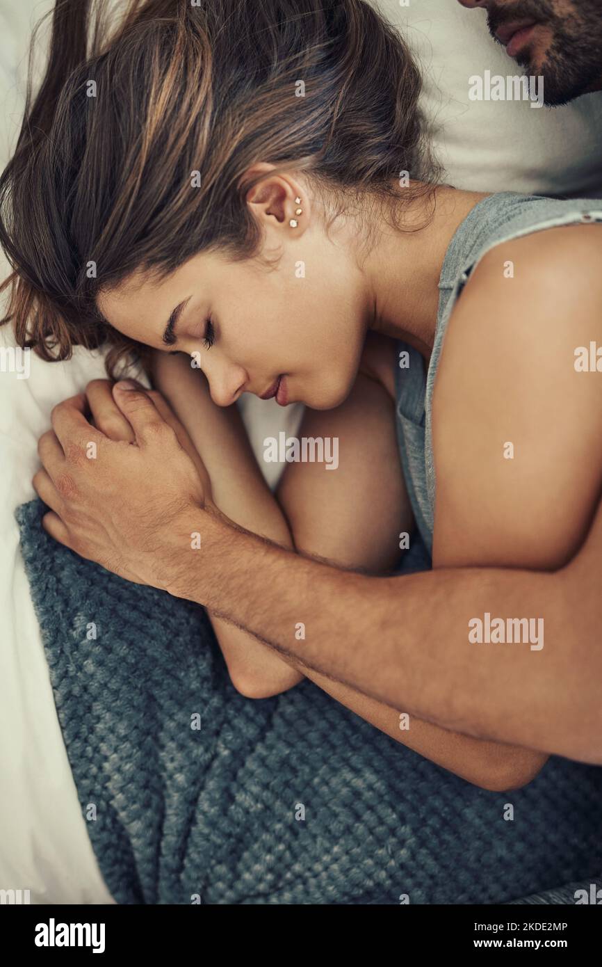 The most comfortable place to sleep. High angle shot of an affectionate young couple sleeping in their bed. Stock Photo