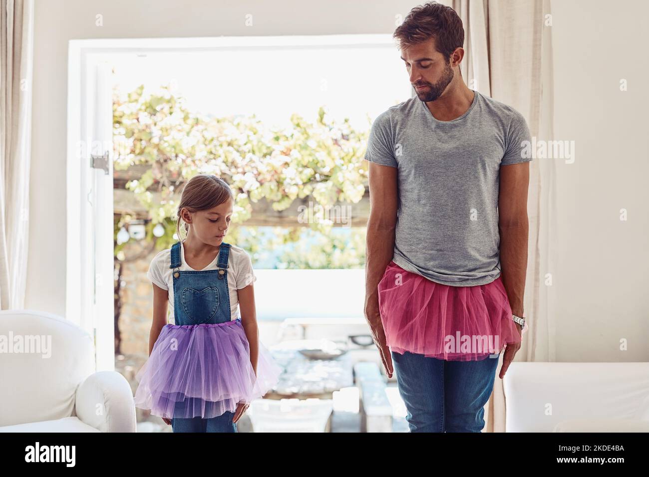 We love to boogie. a father and daughter dancing in their tutus. Stock Photo