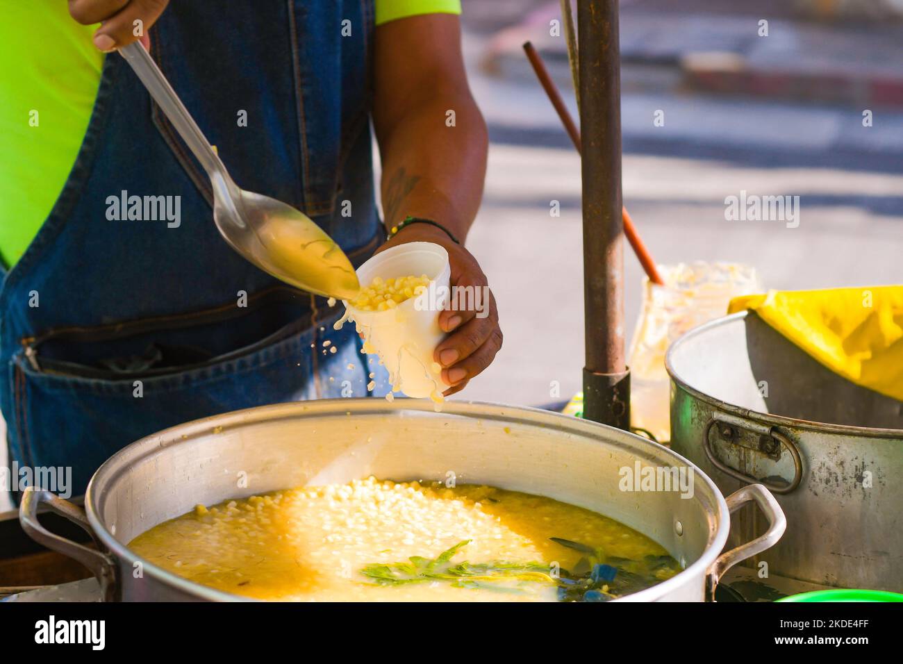 Serving Esquites in a disposable cup, traditional Mexican street food