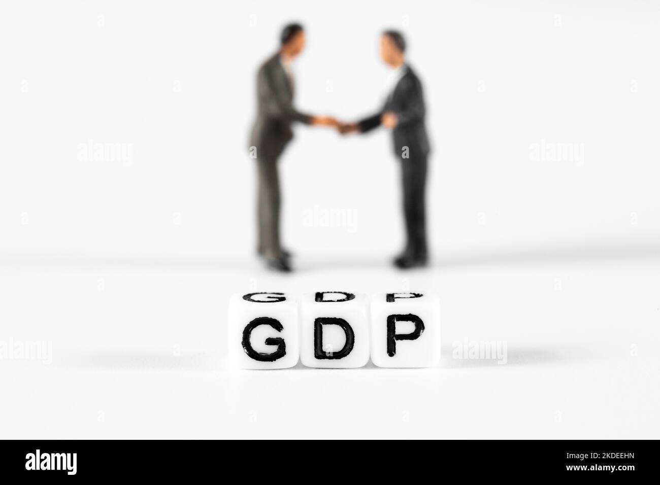 GDP on beads with two scale model businessmen, shaking hands, in the background. Britain cost of living crisis concept Stock Photo