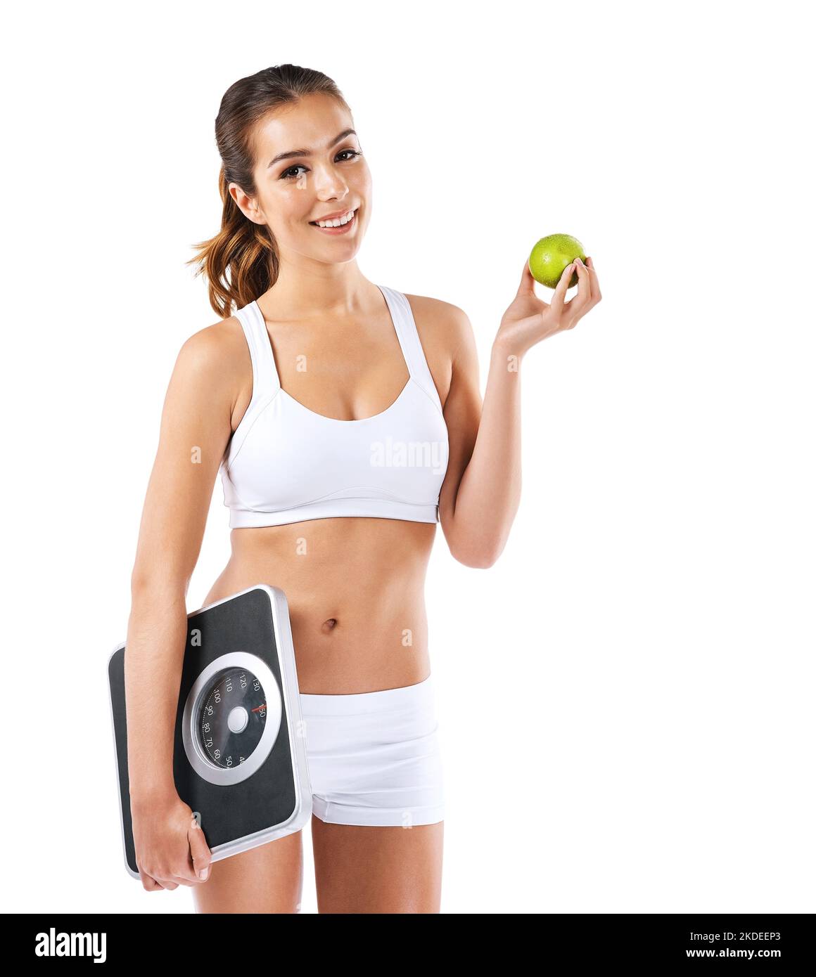 https://c8.alamy.com/comp/2KDEEP3/the-only-thing-worth-losing-is-weight-a-young-woman-eating-an-apple-while-holding-a-scale-2KDEEP3.jpg
