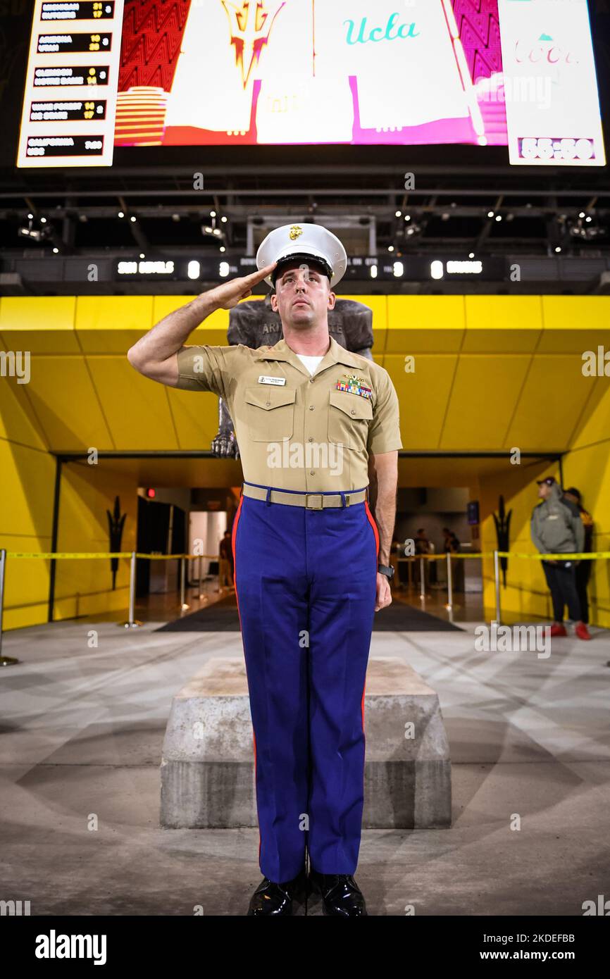 Soldier stands in salute in front of the Pat Tillman statue before an NCAA college football game between the Arizona State Sun Devils and the UCLA Bru Stock Photo