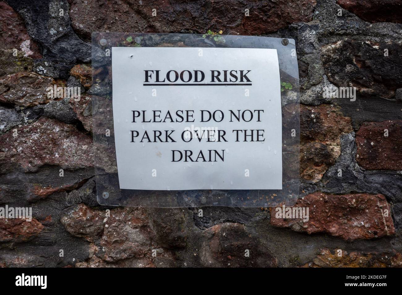 Flood risk sign on a brick wall Stock Photo