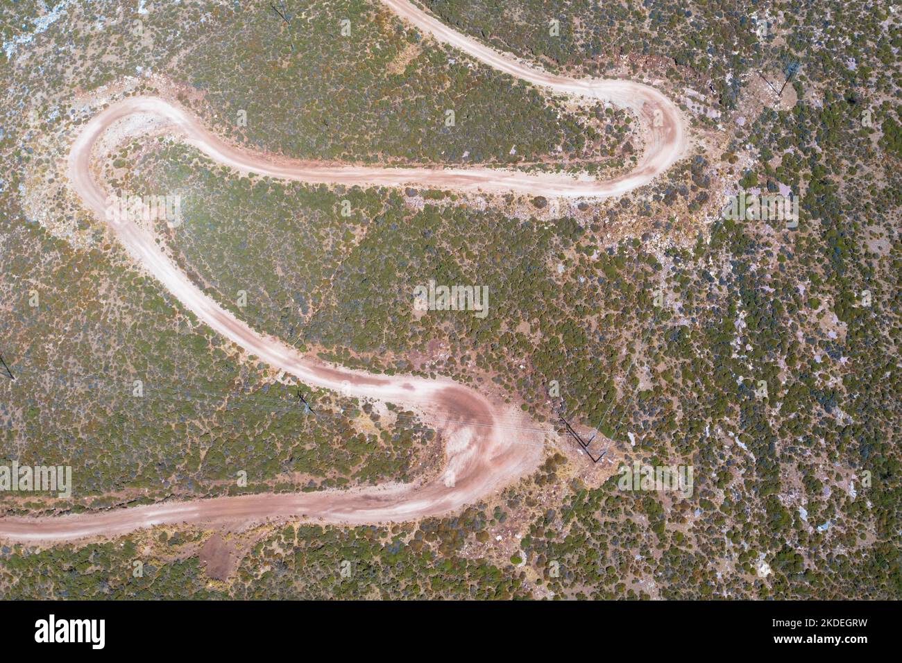 Spectacular aerial view with serpentine off-road track to top of Attavyros mountain. Highest mountain  in Rhodes island, Greece. Stock Photo