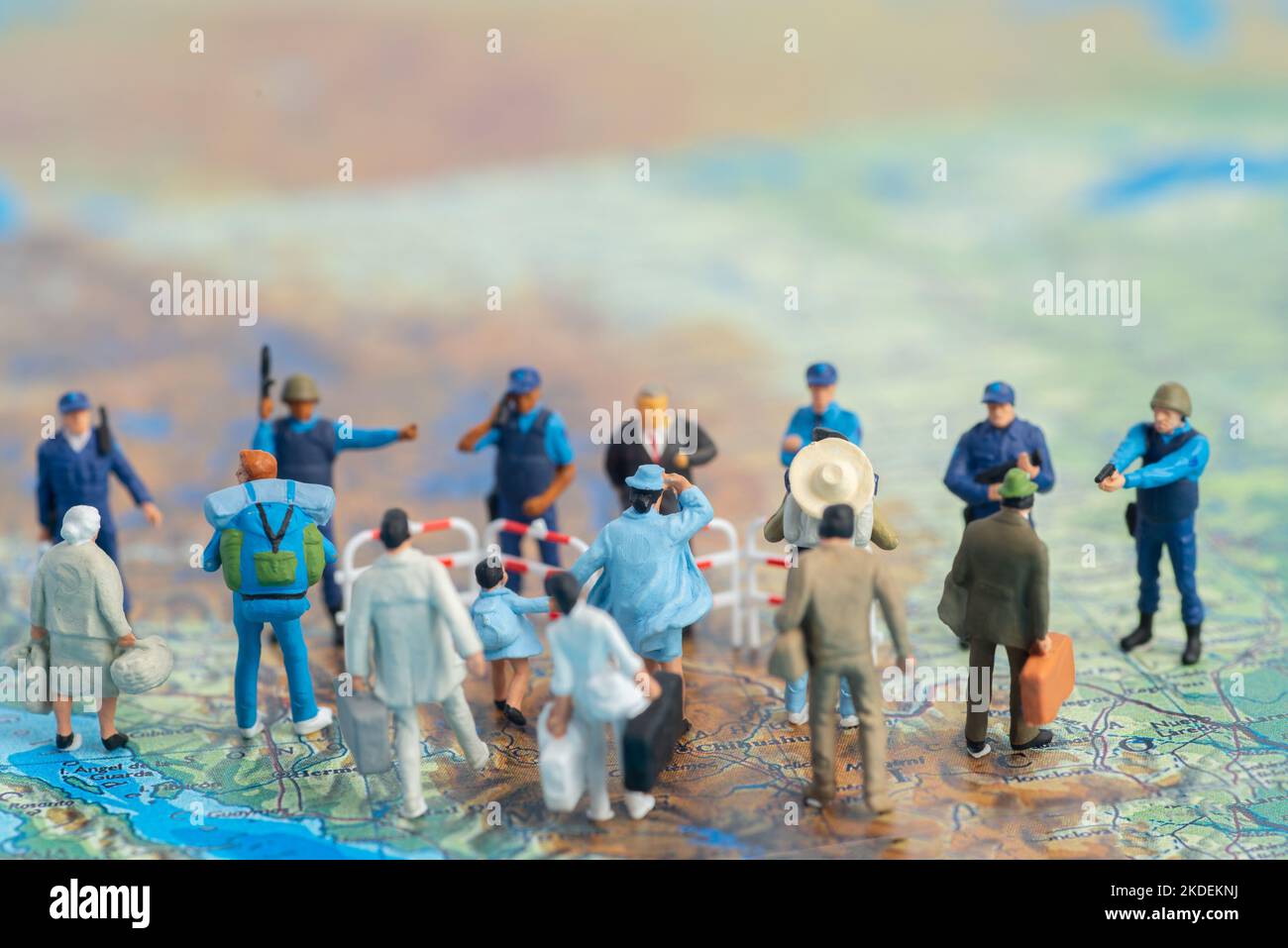 Miniature toy people concept US border patrols against a group of migrant from Mexico Stock Photo