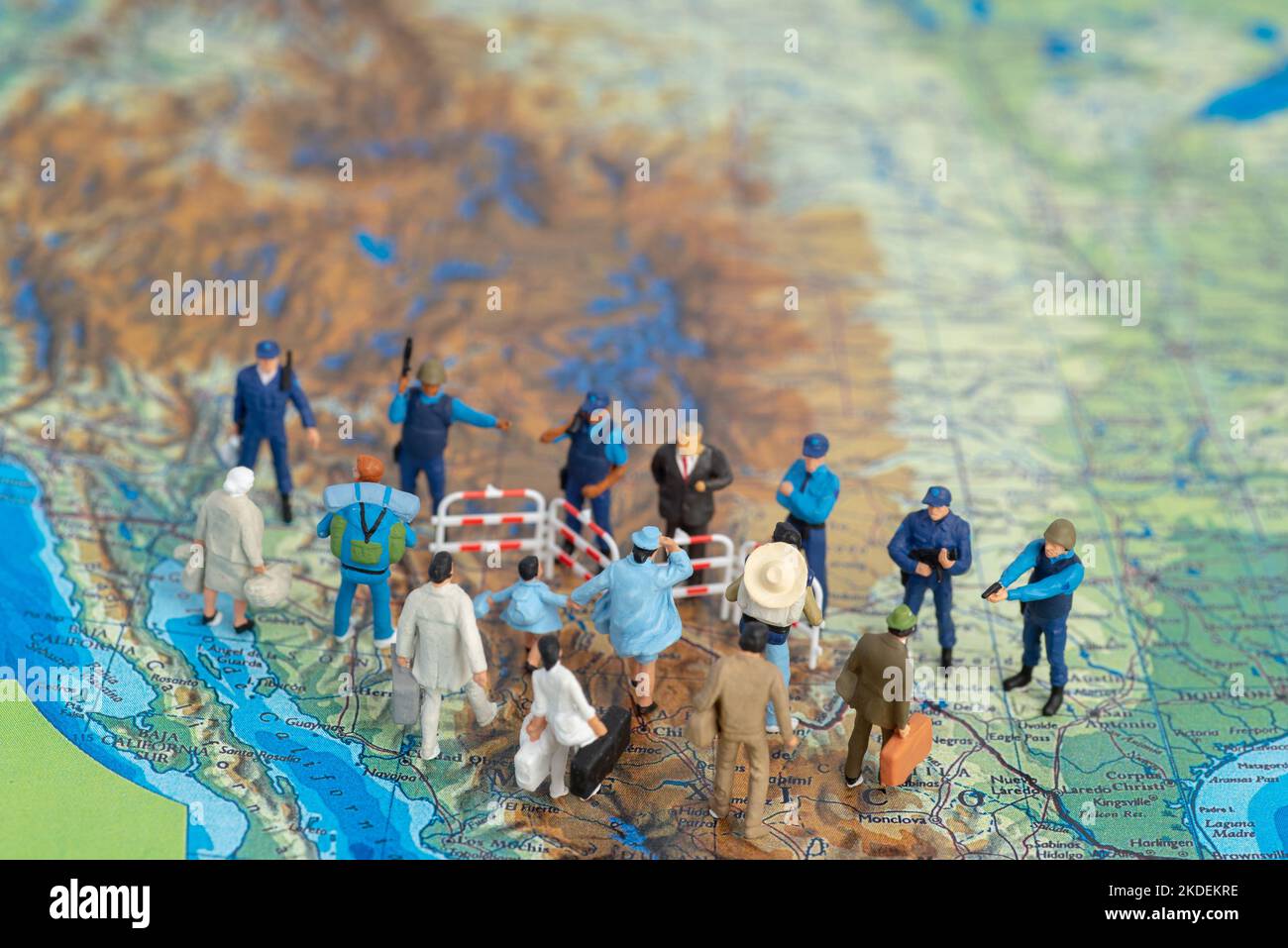 Miniature toy people concept US border patrols against a group of migrant from Mexico Stock Photo