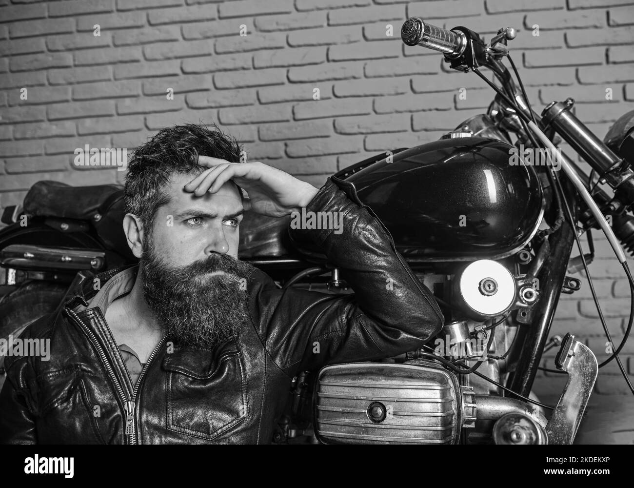 Bikers lifestyle concept. Man with beard, biker in leather jacket near