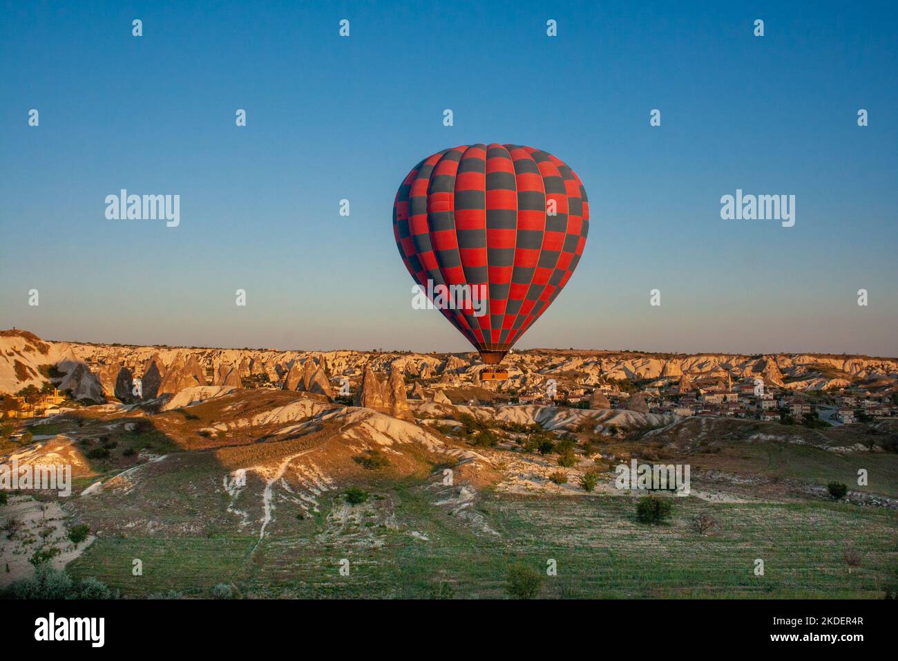 hot air balloons rise over the chimneys rock formation, Cappadocia