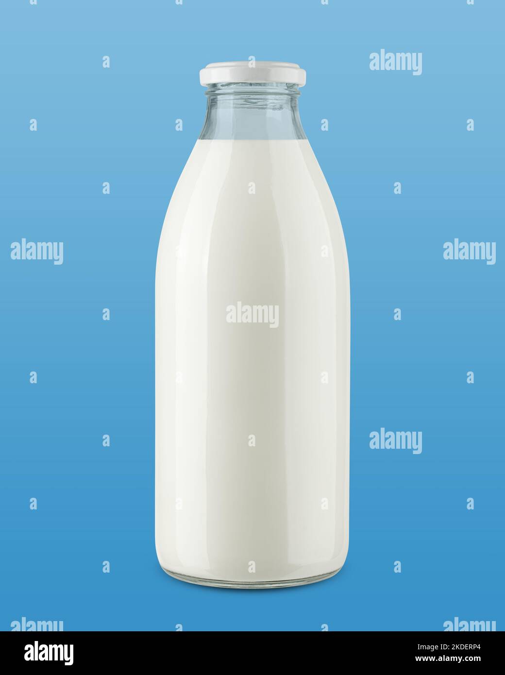 Milk in glass on blue background, full depth of field Stock Photo