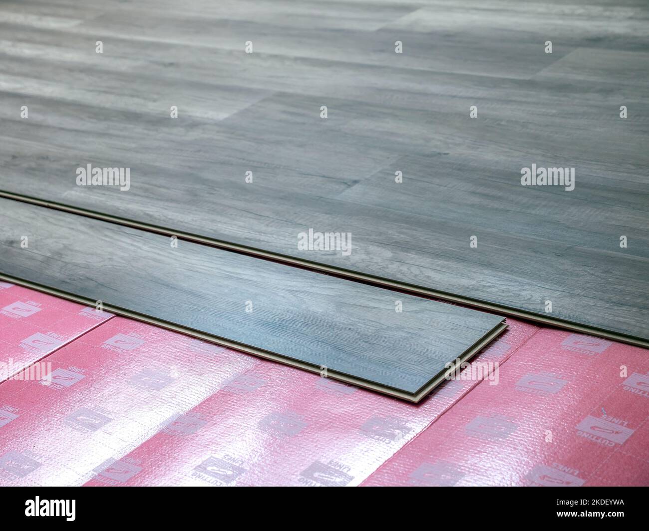 Laying new laminate panel floor in house apartment Stock Photo