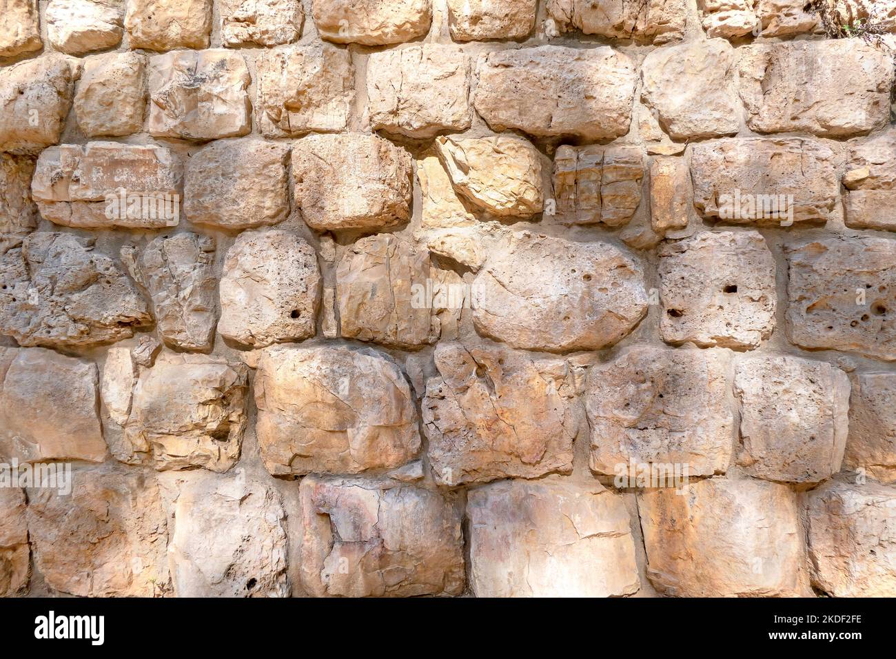 Texture of wall surface made of unevenly cut Jerusalem stones. Isarel