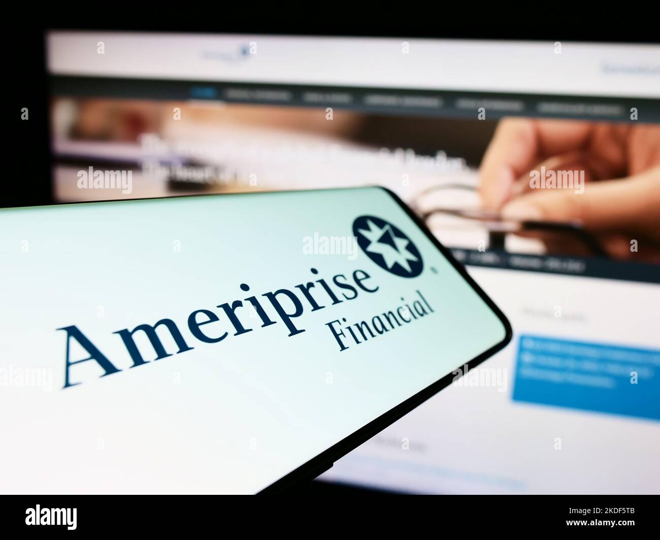 Smartphone with logo of American company Ameriprise Financial Inc. on screen in front of business website. Focus on center-right of phone display. Stock Photo