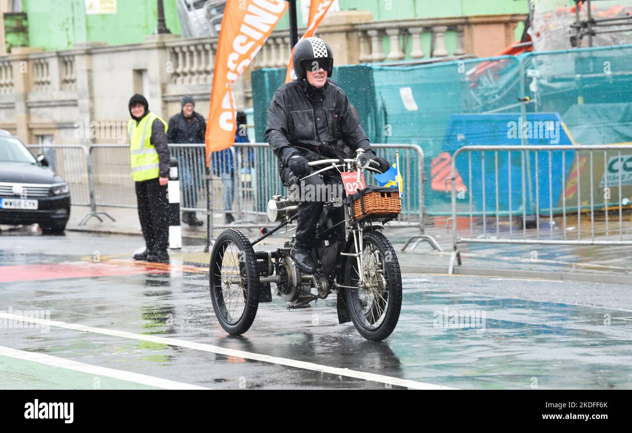 Brighton UK 6th November 2022 - Participants brave the torrential rain along  Brighton seafront as they complete the annual RM Sotheby's London to Brighton Veteran Car Run today . The Run is open to four-wheeled cars, tri-cars and motor tricycles manufactured before 1st January 1905 : Credit Simon Dack / Alamy Live News Stock Photo