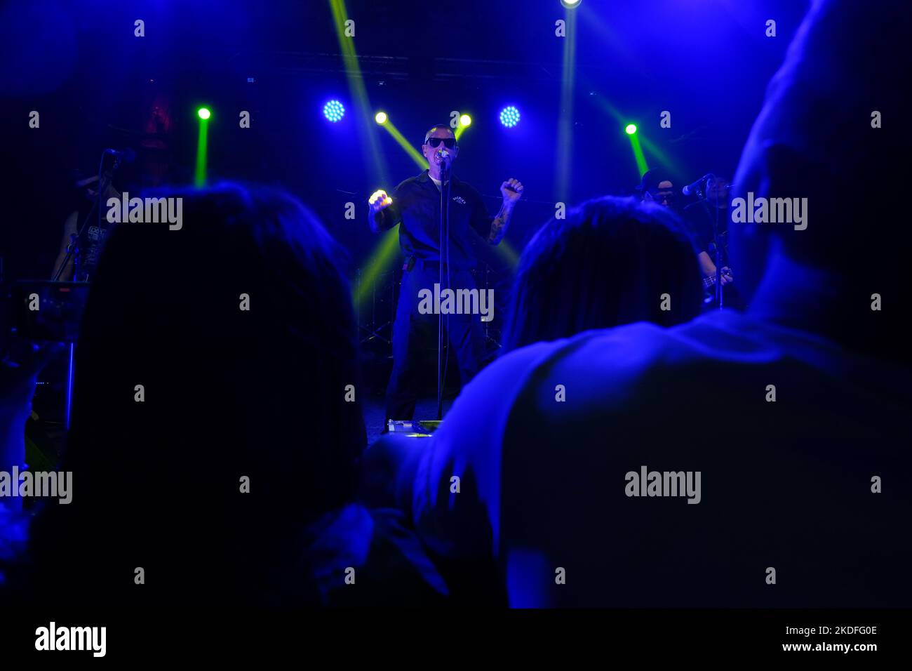 TBILISI, GEORGIA - OCTOBER 23, 2022: Male vocalist, singer holds a microphone and sings a song on stage. Musical performance, rock band concert. Serge Stock Photo