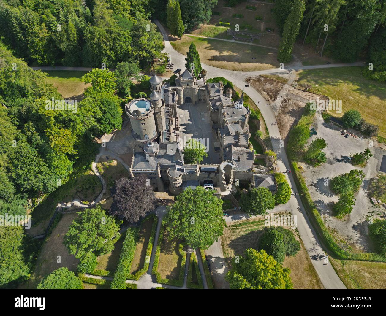 A high angle shot of the lowenburg castle in a park with green trees in Kassel, Germany Stock Photo