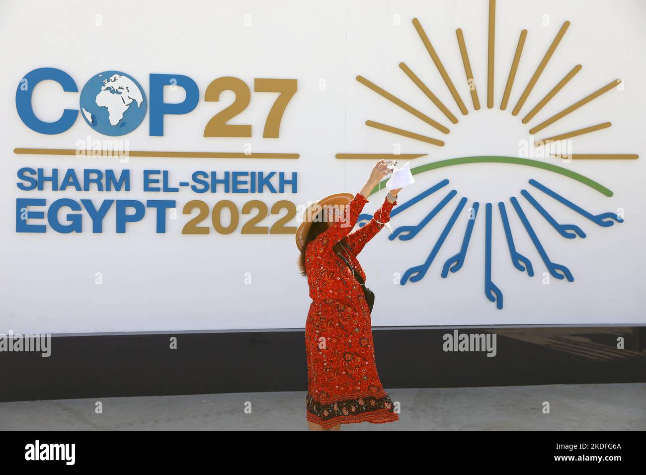 Sharm El Sheikh. 6th Nov, 2022. A woman takes pictures in front of a display board of the 27th Conference of the Parties of the United Nations Framework Convention on Climate Change (COP27) in Sharm El-Sheikh, Egypt, Nov. 6, 2022. The COP27 opened on Sunday in Egypt's coastal city of Sharm El-Sheikh in hopes to turn global climate finance pledges into action. Credit: Sui Xiankai/Xinhua/Alamy Live News Stock Photo