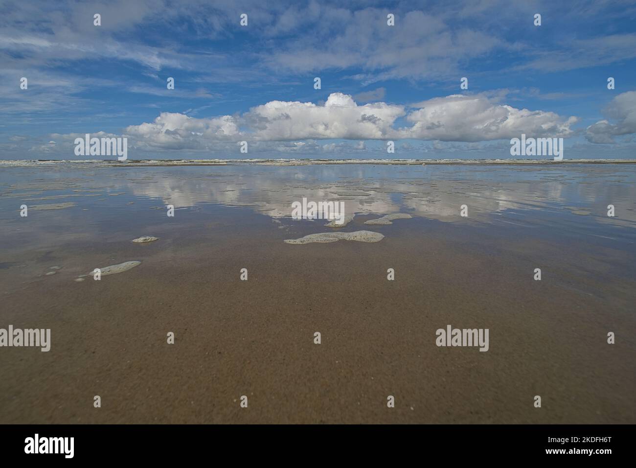 The clouds are reflected in the calm waters of the North Sea Stock Photo