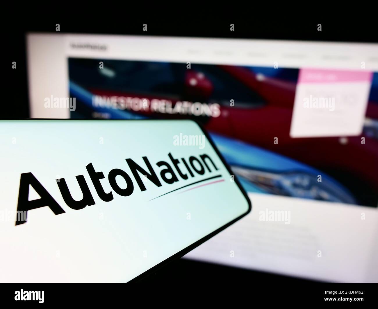 Cellphone with logo of American automotive retail company AutoNation Inc. on screen in front of business website. Focus on left of phone display. Stock Photo