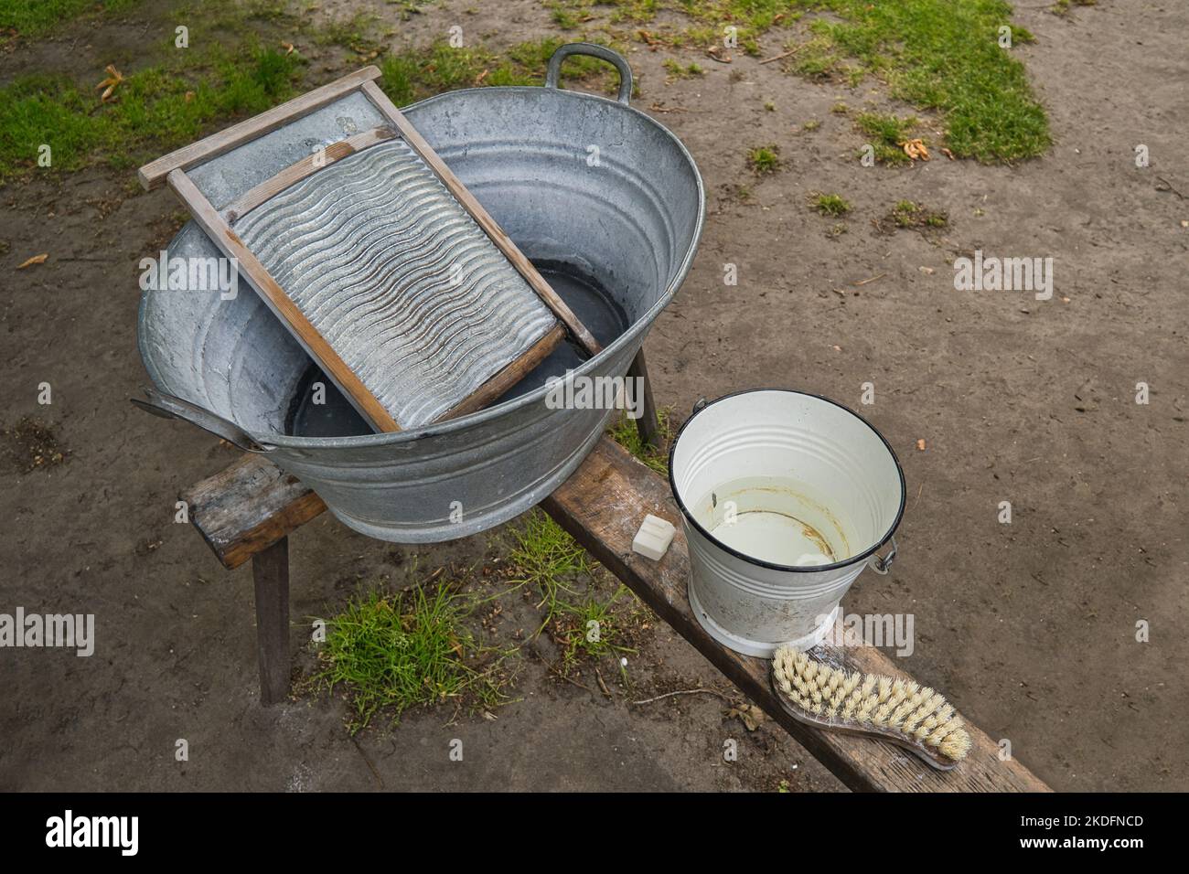 Old tin tub and traditional utensils for washing clothes Stock Photo