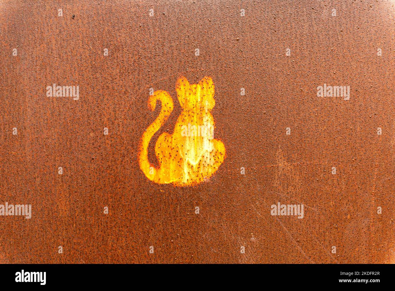 silhouette of a cat on rusted sheet metal Stock Photo