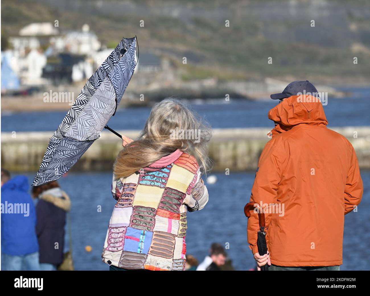 Lyme Regis, UK. 06th Nov, 2022. ON a very windy afternoon with mixed weather a person is seen black and white umbrella blown inside out. Picture Credit: Robert Timoney/Alamy Live News Stock Photo