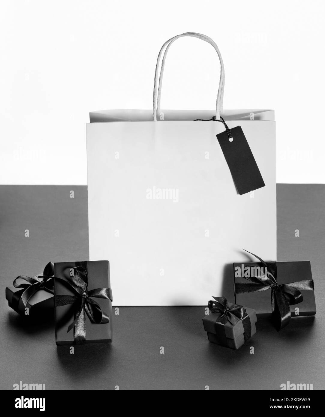 White paper shopping package, black wrapped boxes on black and white. Black friday, online shopping, Boxing day, Father's day, Valentine's day, Christ Stock Photo