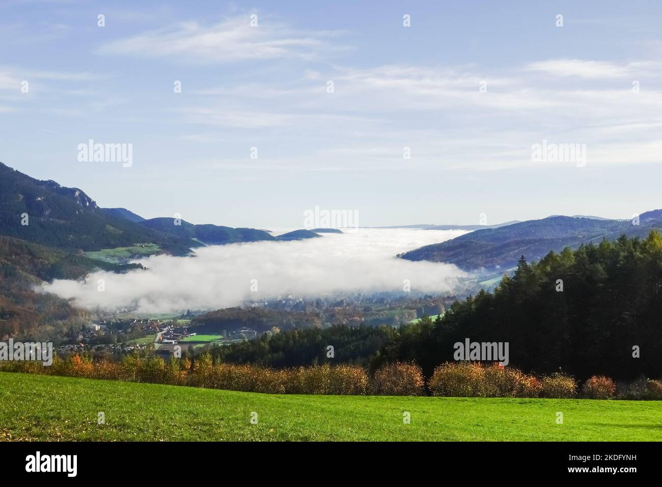 amazing dense white fog in a valley with colorful landscape detail view Stock Photo