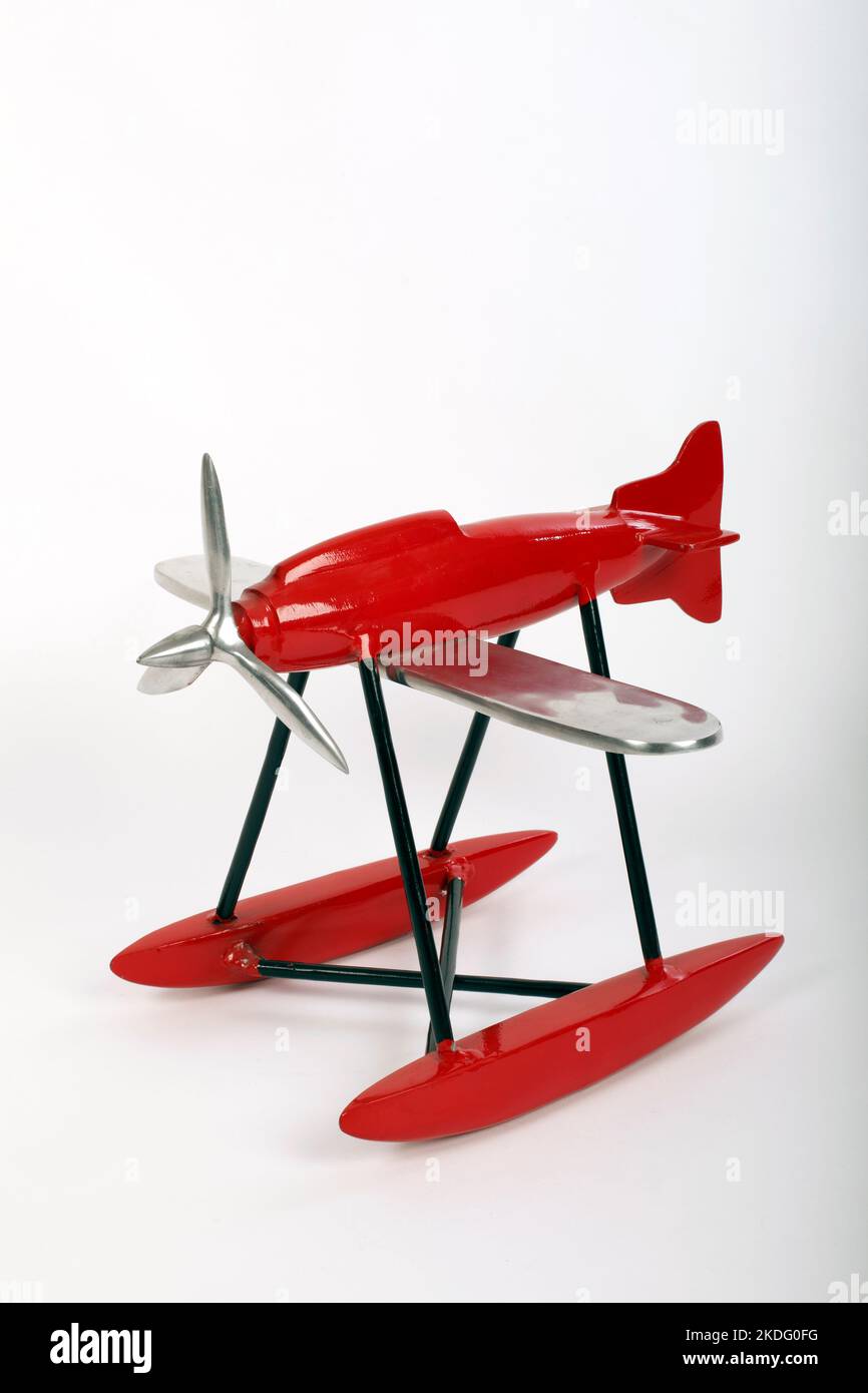 Metal red and black model of a supermarine floatplane, or single engined flying boat. Stock Photo