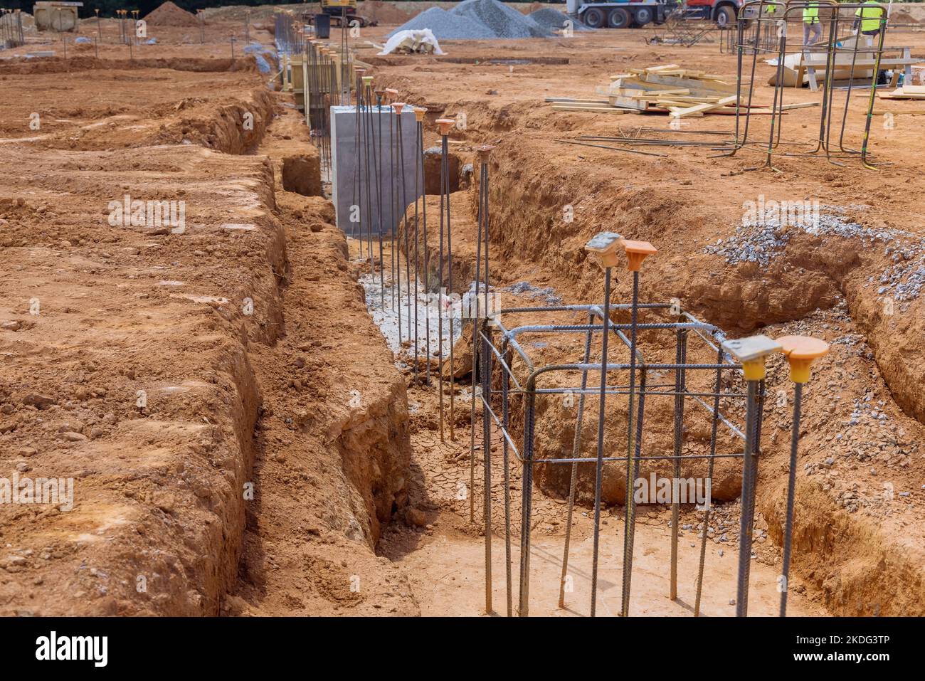 Trench for concrete foundation is reinforced with steel bars rebar wires at construction site as part reinforcement process Stock Photo