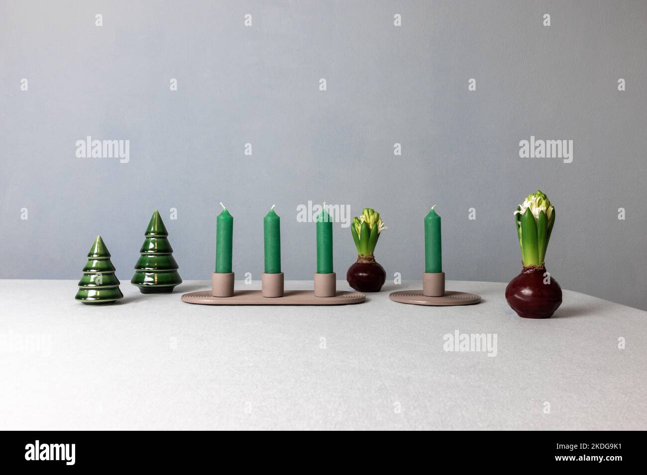 Advent candles stand on a table with hyacinths and decorations in the
