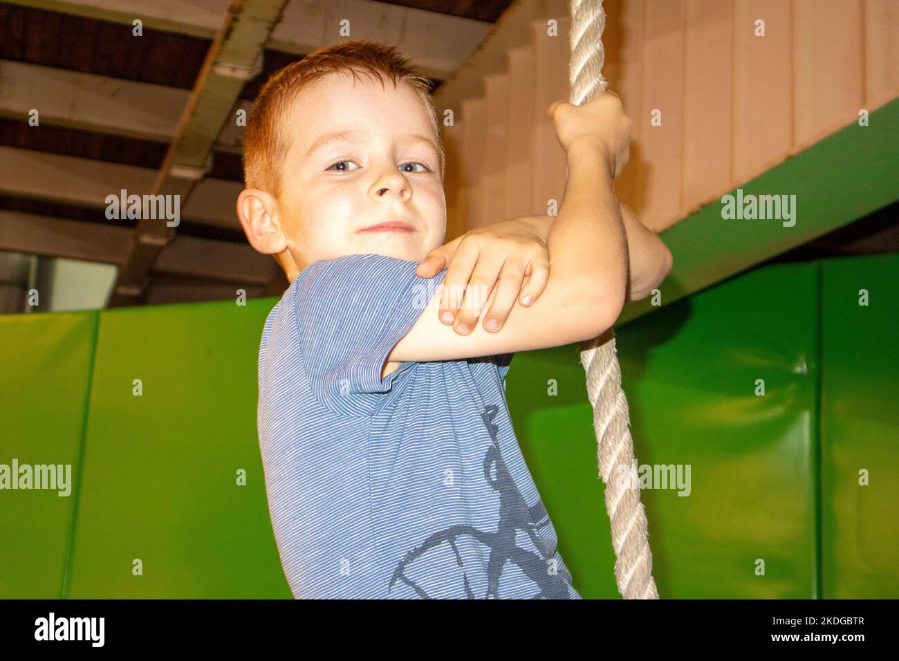 a little boy is hanging on a rope Stock Photo Alamy