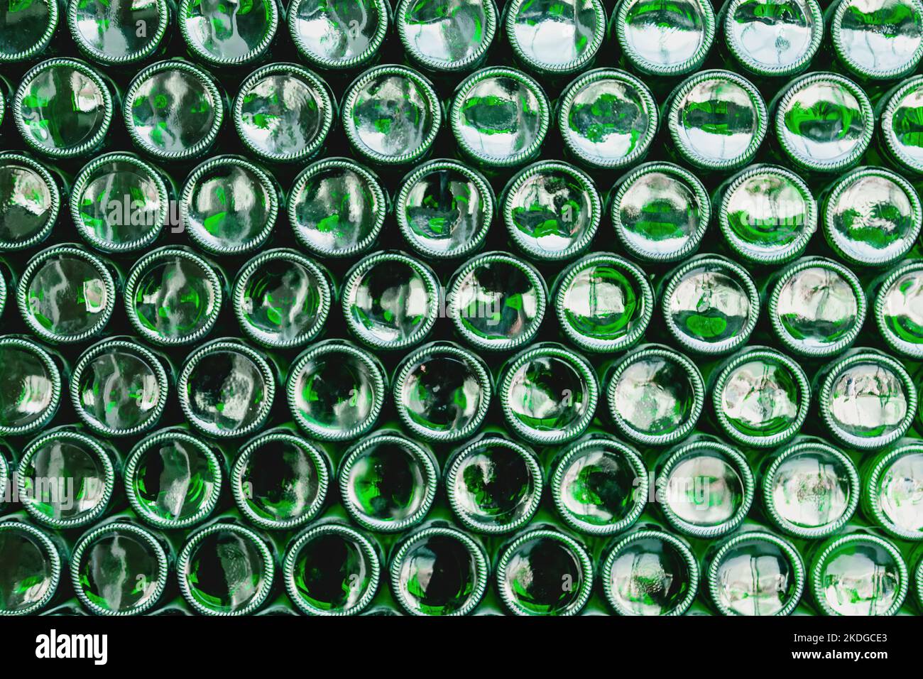 Glass bottles green. Green glass bottles of beer. Wall formed by green