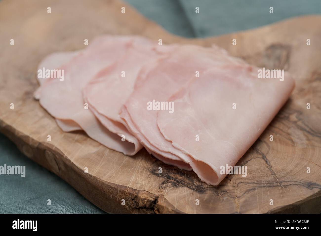 Prosciutto cotto on olive serving board, shallow focus Stock Photo Alamy