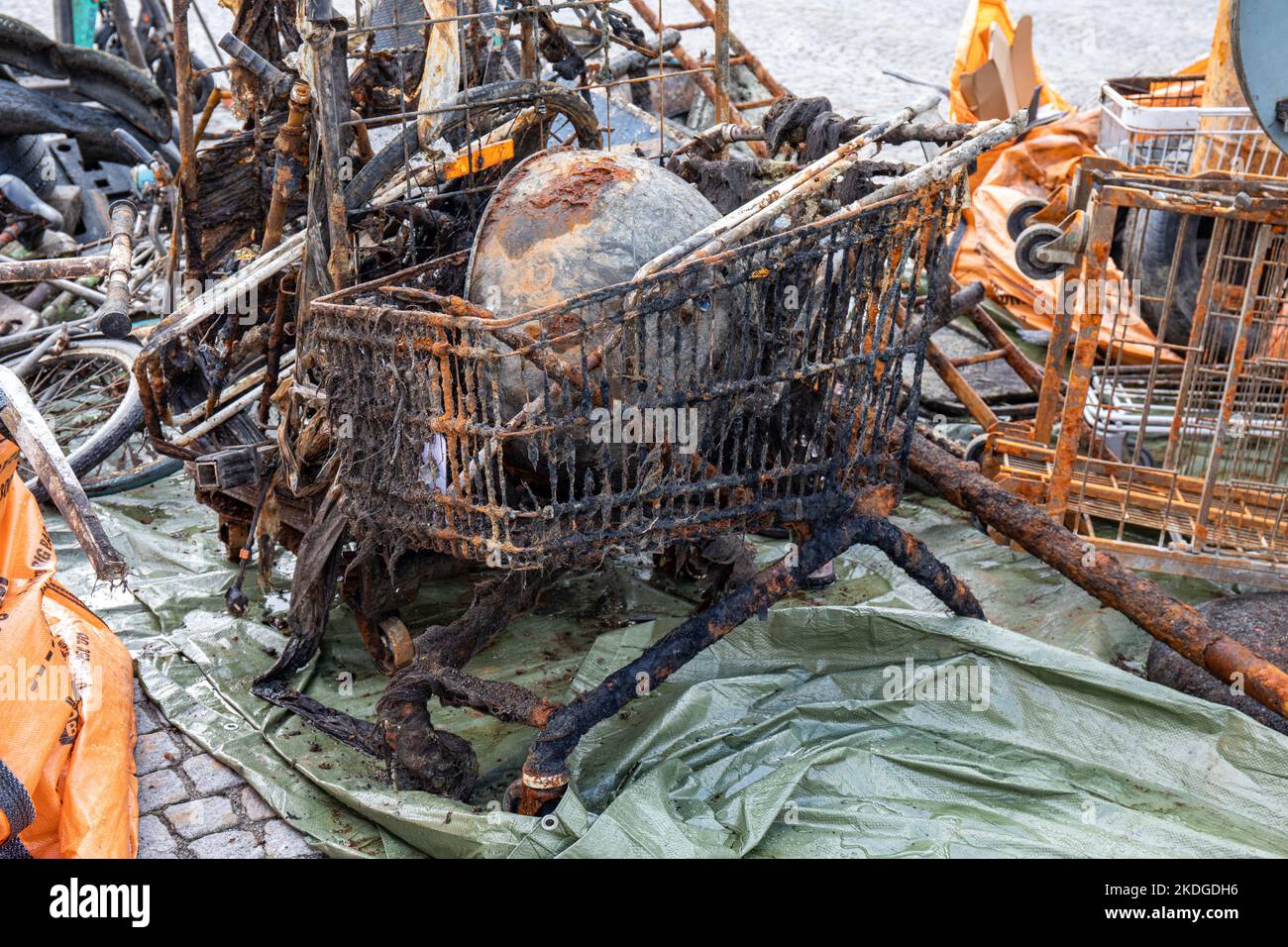 Rusty old shopping cart and other items salvaged from sea in Nybroviken, Stockholm, Sweden Stock Photo