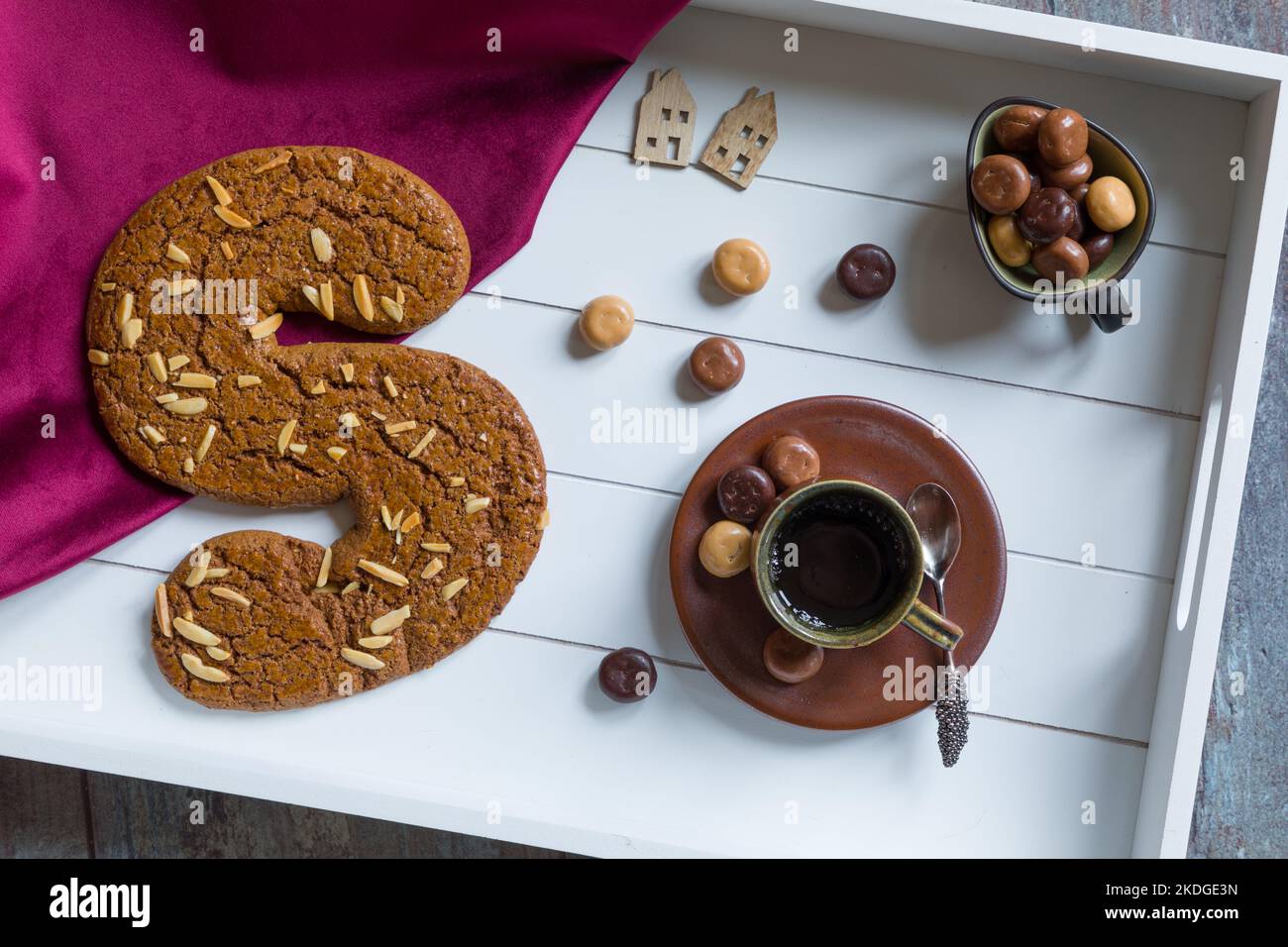 A cup of coffee and spiced bisquit called speculaas on a tray to celebrate 'het heerlijk avondje van Sinterklaas', the traditional Saint Nicolas eveni Stock Photo
