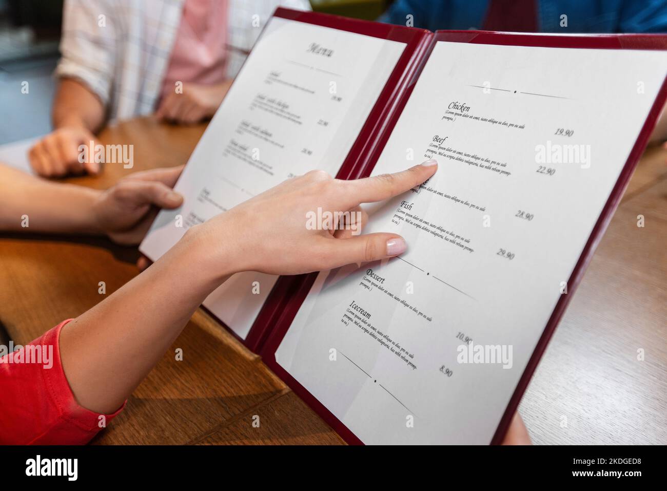 close up of couple with menu at restaurant Stock Photo