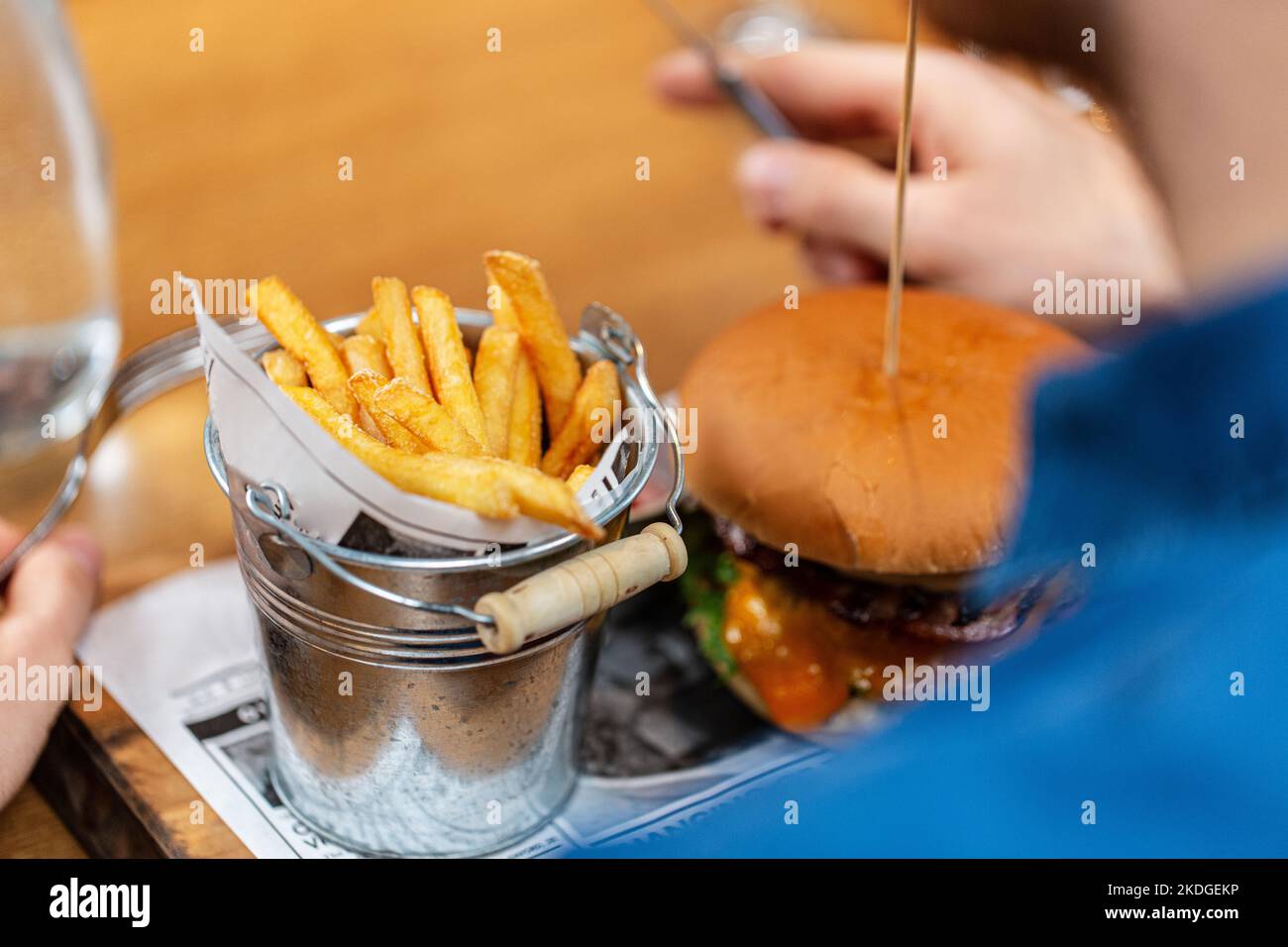 close up of man eating burger and french fries Stock Photo
