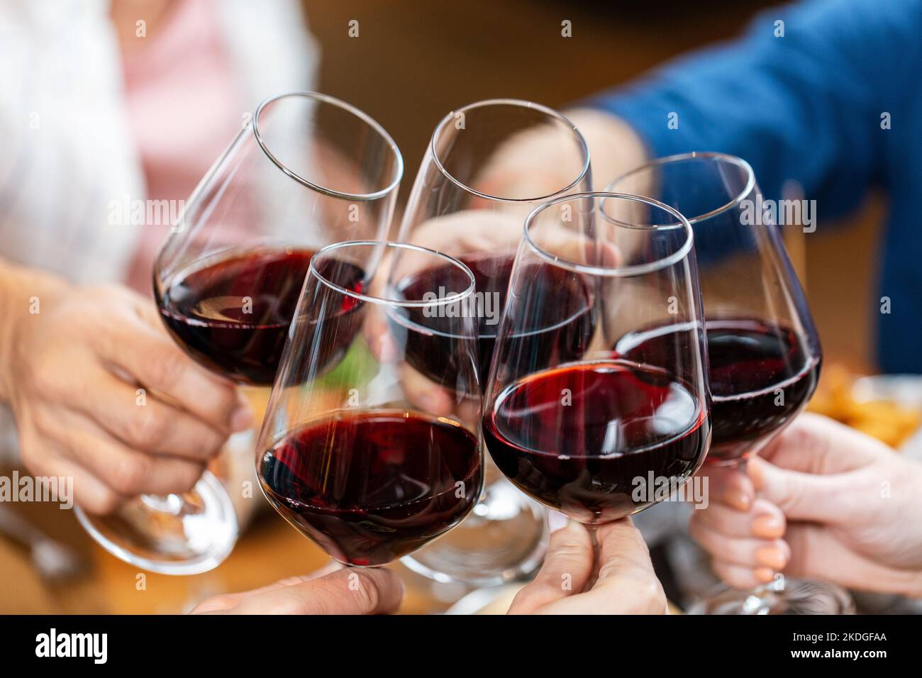 happy friends drinking red wine at restaurant Stock Photo
